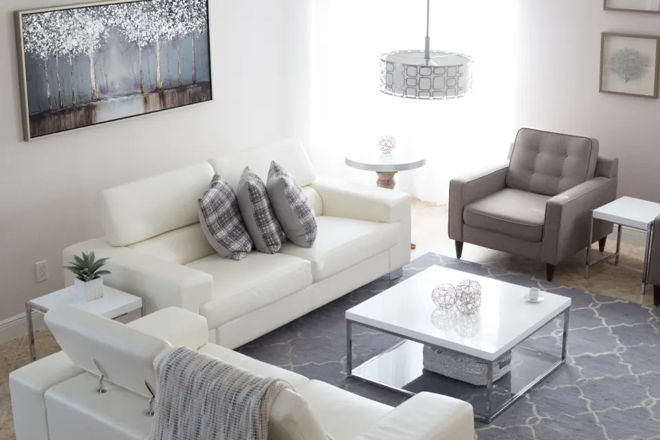 Bright staged living room with white sofa and modern decor