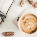 Cup of coffee beside an open book during a calm morning routine
