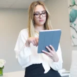 Woman reading articles on a tablet to check reliable information