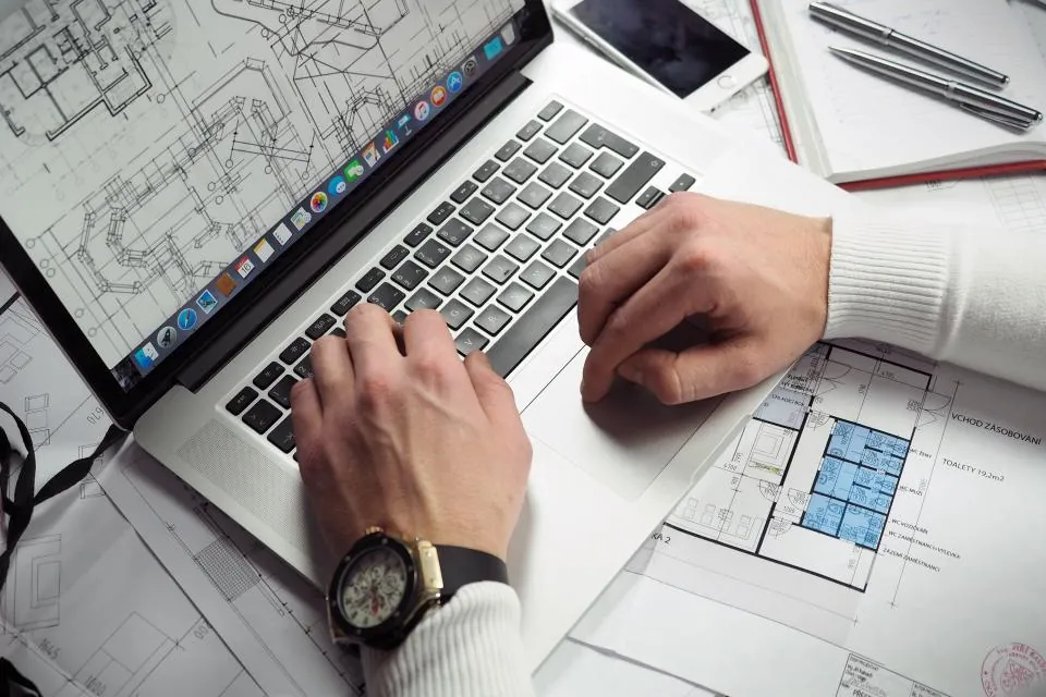 Entrepreneur sketching a small business plan on a laptop